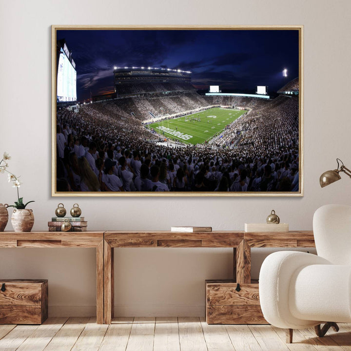 A packed football stadium at night, with bright lights and fans in white, depicted in a Michigan State Spartans Stadium wall art.