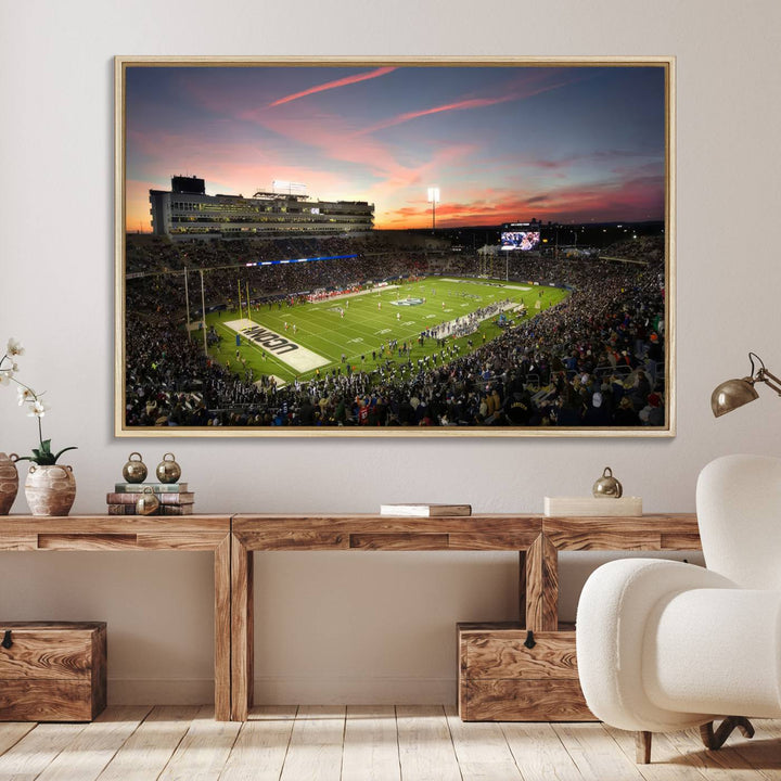 This wall art canvas print captures UCONN Huskies fans energizing a sunset scene at East Hartfords Pratt & Whitney Stadium.