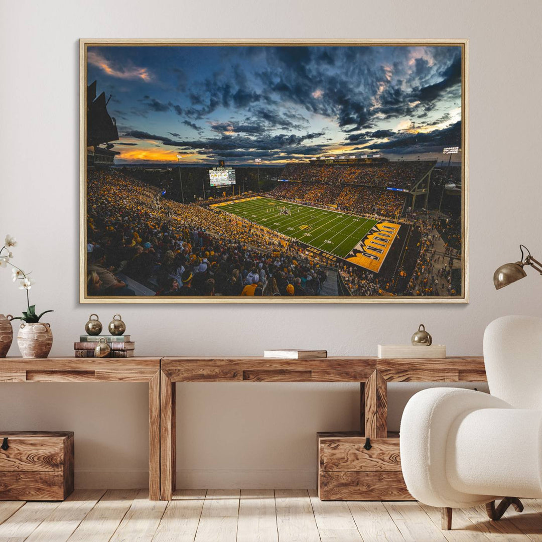 Laramies War Memorial Stadium Print captures a stunning scene of the stadium during sunset, set under a partly cloudy sky illuminated by bright lights.