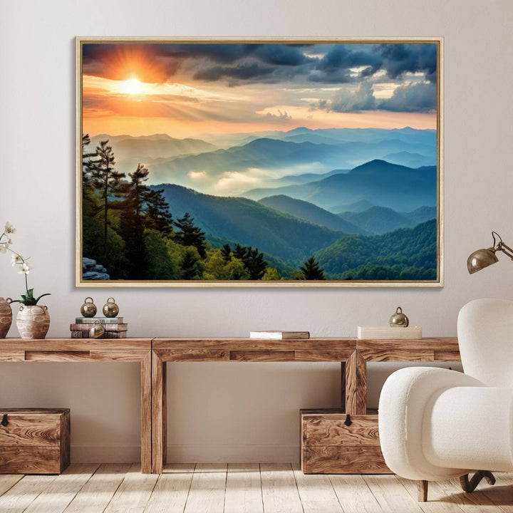 The wall art, titled Sunrise Over Mountain Range, is a canvas print that beautifully depicts layers of hills, scattered trees, and a partly cloudy sky.