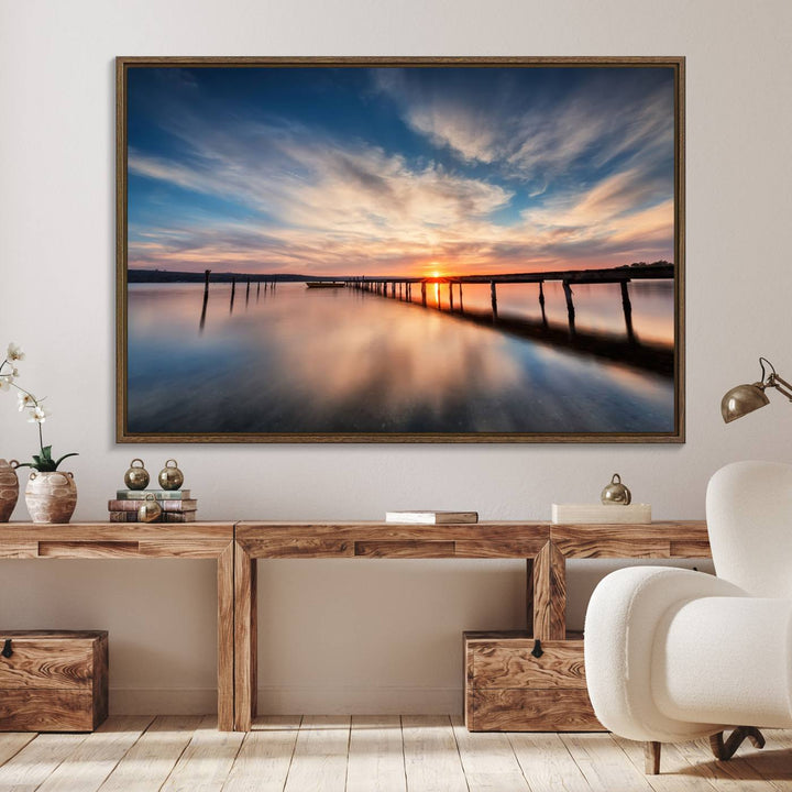 The Sunset Pier Canvas features a serene coastal landscape with vibrant hues under cloudy skies, ideal for modern decor.