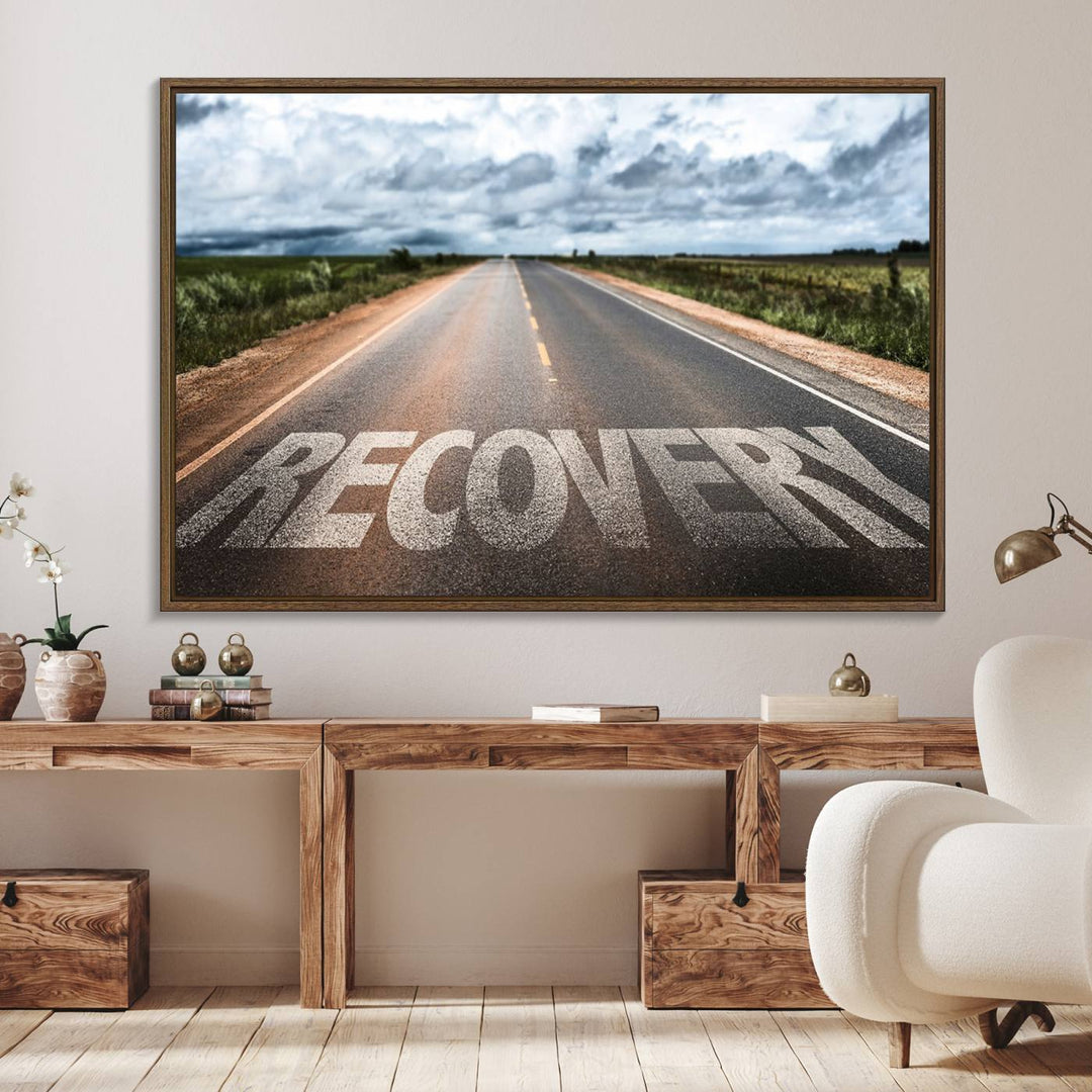 The Recovery Road Wall Art Canvas Print depicts a road under a cloudy horizon.