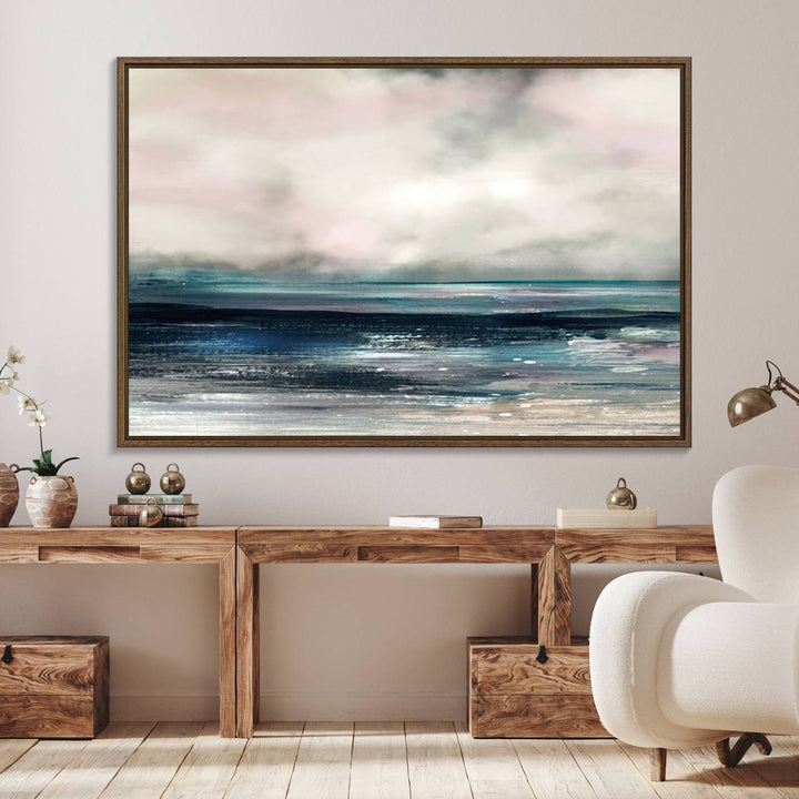 A contemporary abstract wall art canvas print in pastel pink, teal, and gray tones hangs on the wall.