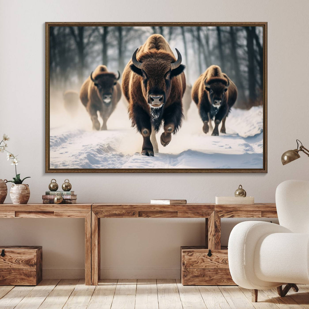 Wall art titled Cow Bighorn shows three bison running through snow in a forest.