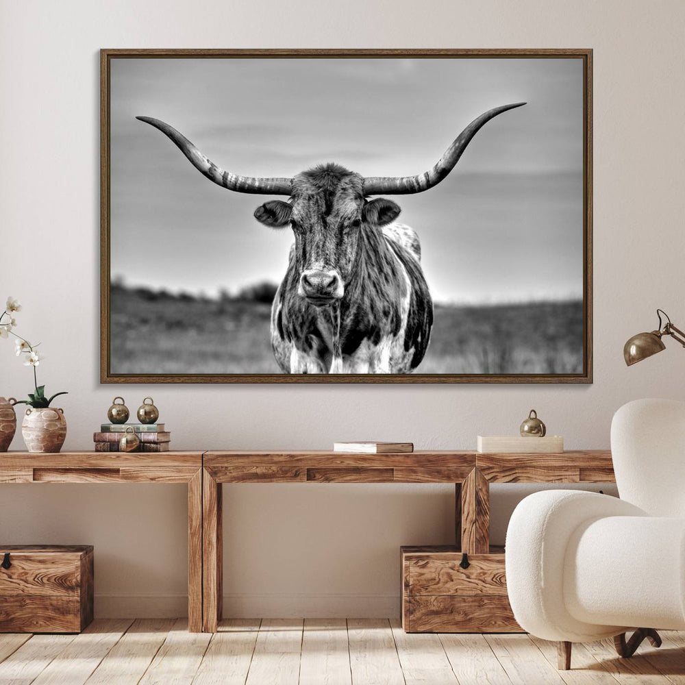 The Texas Longhorn Cow wall art, divided into three panels, is of gallery quality and displayed on a dark wall.