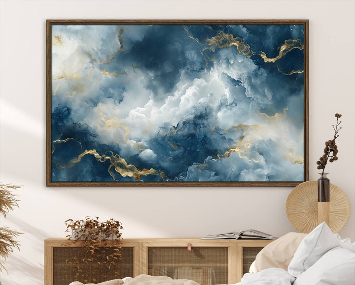 The "Large Abstract Print - Luxe Blue and Gold Abstract Canvas Wall Art" features a bold cloudscape design with swirling white patterns, ideal for modern home decor in living rooms or offices.