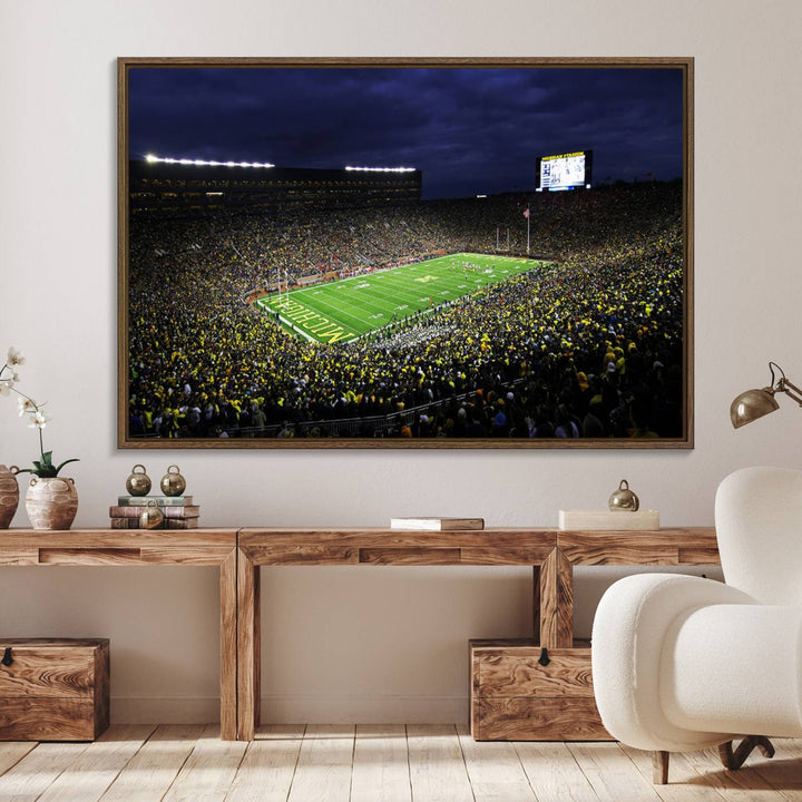 A painting of the packed Michigan Wolverines football stadium at night.