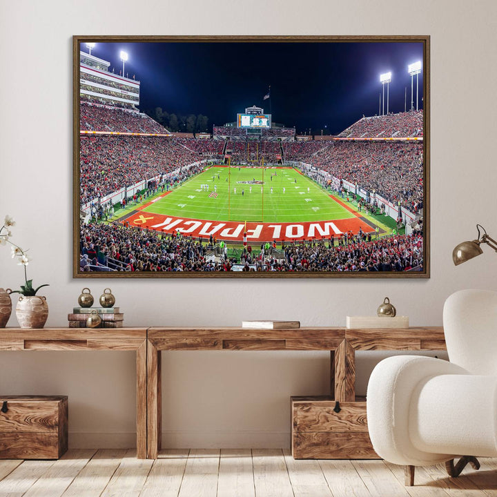 A NC State Wolfpack Football Team print of Carter-Finley Stadium at night features WOLFPACK illuminated brightly in the end zone grass.