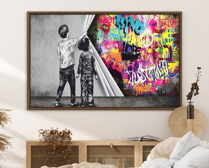 The Banksy Print - Street Art Canvas features a vibrant and bold image of two children lifting a curtain to reveal colorful graffiti. It's ready to hang, adding an urban modern decor vibe.