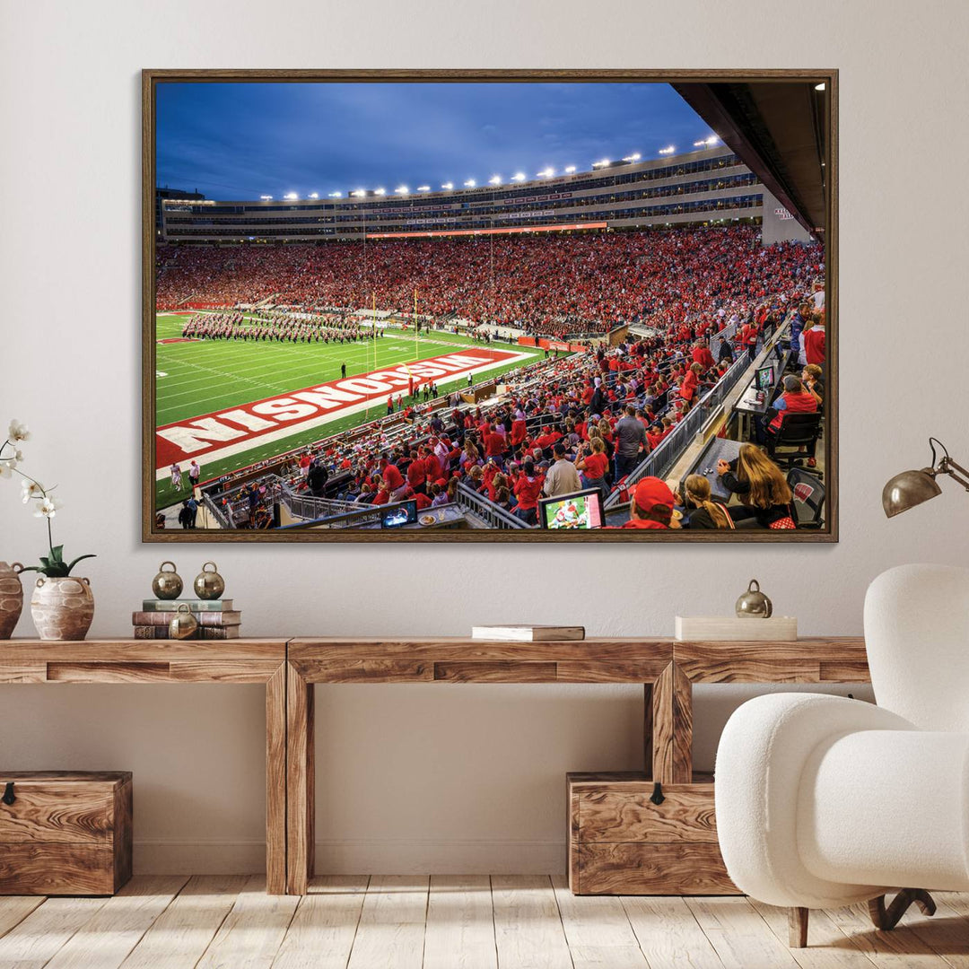 A vibrant wall art captures the essence of Madison Camp Randall Stadium, depicting a sea of fans in red and white during a Wisconsin Badgers football game under bright lights.