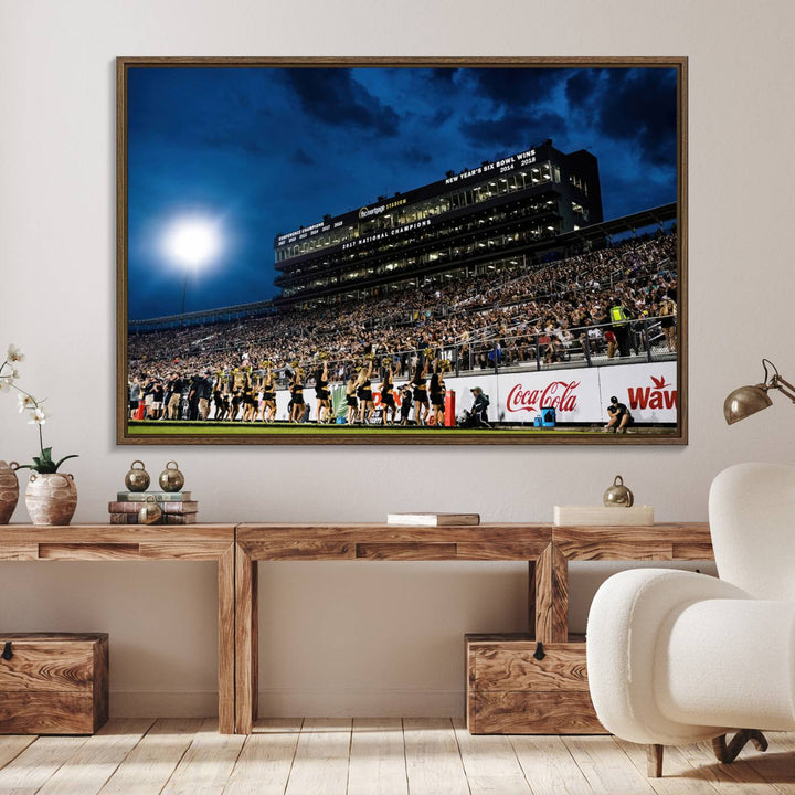 A gallery-quality canvas print depicting a stadium packed with fans under a night sky, highlighting the UCF Knights Football Team.