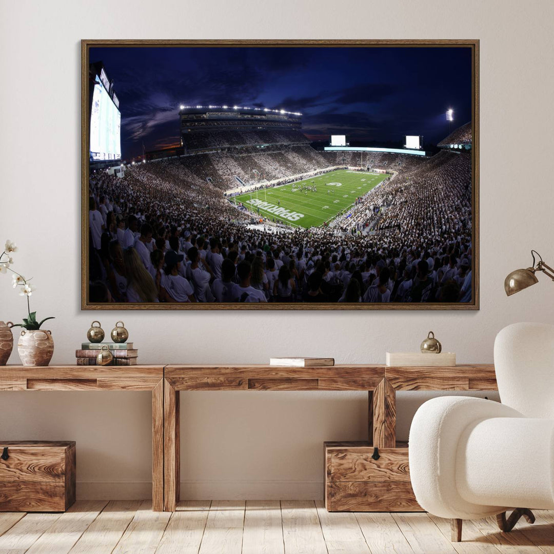 A packed football stadium at night, with bright lights and fans in white, depicted in a Michigan State Spartans Stadium wall art.