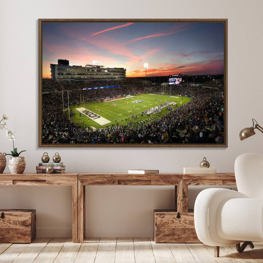 This wall art canvas print captures UCONN Huskies fans energizing a sunset scene at East Hartfords Pratt & Whitney Stadium.