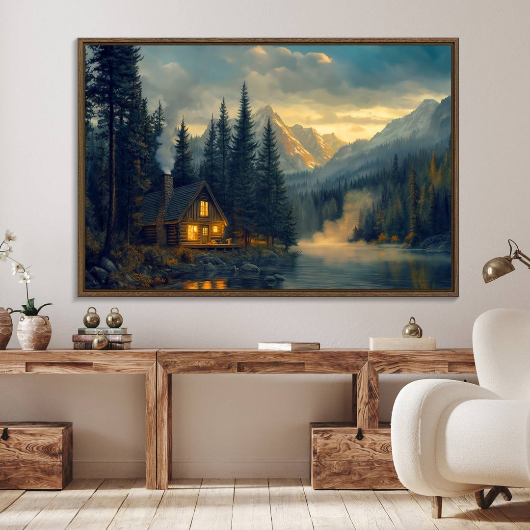 Serene sunset lake wall art: a cozy mountain cabin with lights, framed by pine trees and set against a moody sky. Ideal for adding rustic lodge charm to your space.