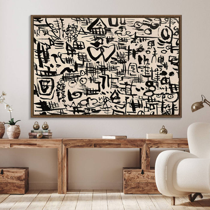 The Abstract Love and Chaos canvas is a museum-quality print featuring black symbols on a beige background, adorned with a heart and scribble design. It is framed to enhance its artistic appeal.