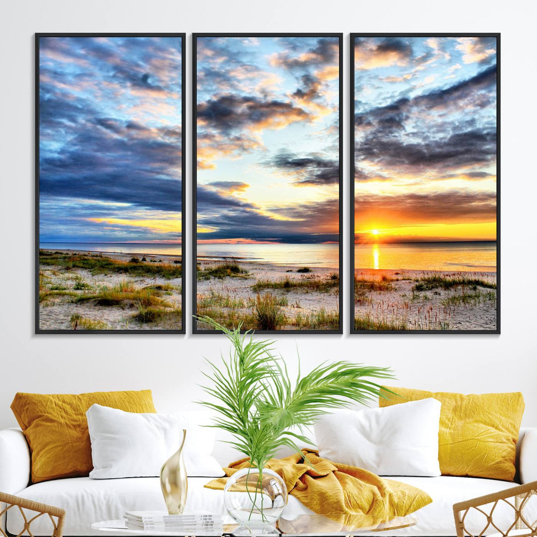 The Sunset On The Ocean canvas wall art features a beautiful beach sunset with grass and clouds.