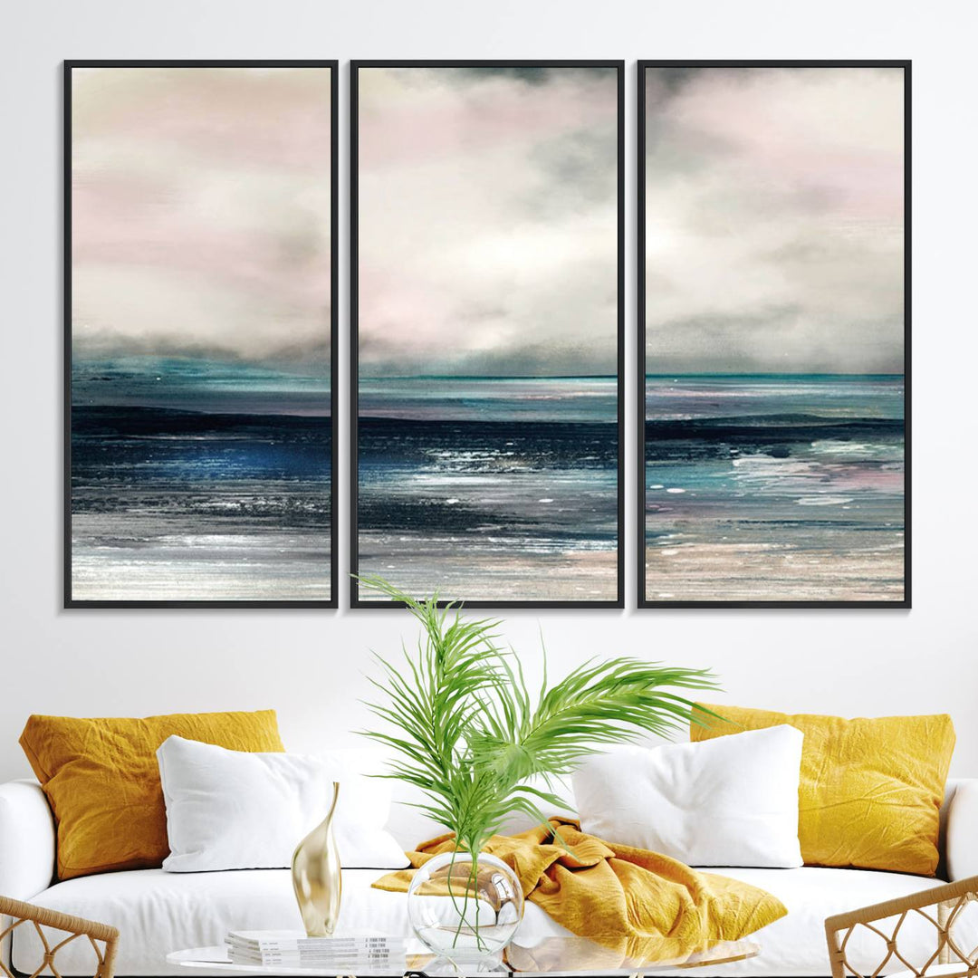 A contemporary abstract wall art canvas print in pastel pink, teal, and gray tones hangs on the wall.