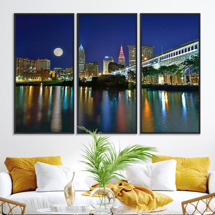 Cleveland City Lights Night Skyline Wall Art canvas showcases a moonlit cityscape reflected on water.