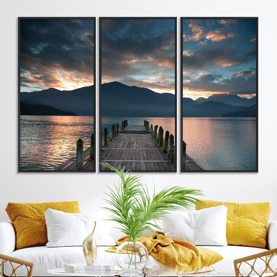 The Mountain Lake Wood Pier Canvas Wall Art depicts a serene lake and mountains, enhancing the beauty of any space.