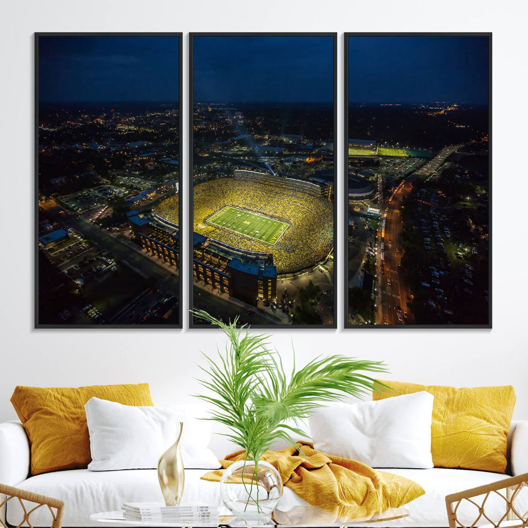 Aerial view of Michigan Stadium at night, surrounded by city lights, depicted on a Michigan Wolverines wall art canvas print.