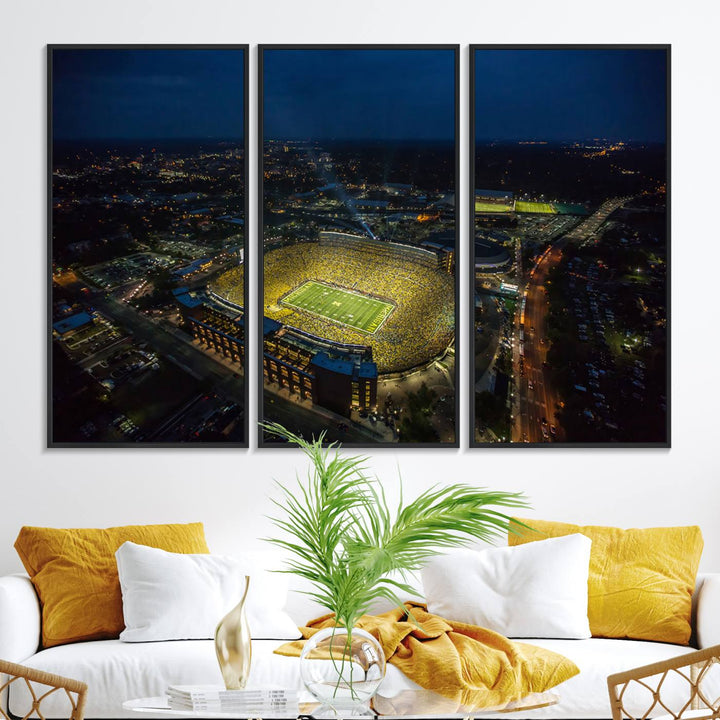 Aerial view of Michigan Stadium at night, surrounded by city lights, depicted on a Michigan Wolverines wall art canvas print.