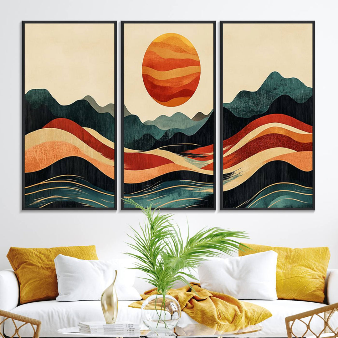 The Mountain Triptych wall art, featuring a design of the sun, mountains, and waves, is displayed prominently on the wall.