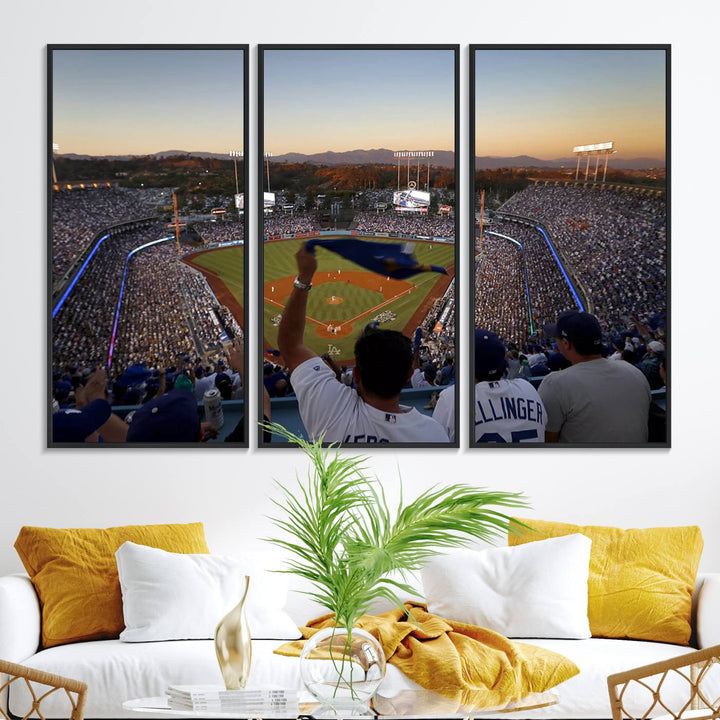 A triple canvas wall art captures the scene at Dodger Stadium, with fans cheering as the sun sets and a flag waving on the field.