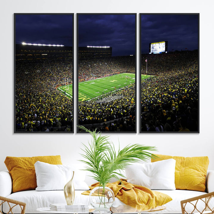 A painting of the packed Michigan Wolverines football stadium at night.