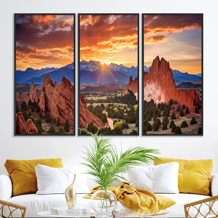 A vibrant sunset over the Rocky Mountains with red rocks.