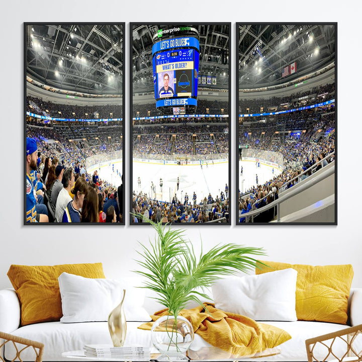 Wall art prints depicting the bustling scenes of the St. Louis Blues being cheered on by a full house at the Enterprise Center, beneath a large scoreboard.