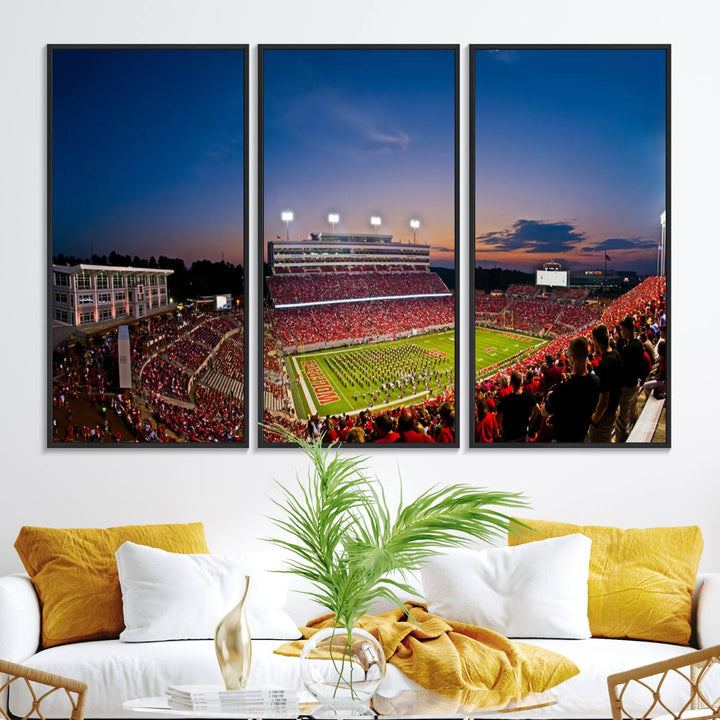 A vibrant and dynamic painting captures the essence of an electrifying night game at Carter-Finley Stadium, highlighting the illuminated atmosphere as the NC State Wolfpack competes under bright stadium lights.