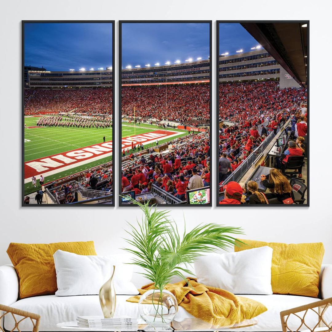 A vibrant wall art captures the essence of Madison Camp Randall Stadium, depicting a sea of fans in red and white during a Wisconsin Badgers football game under bright lights.