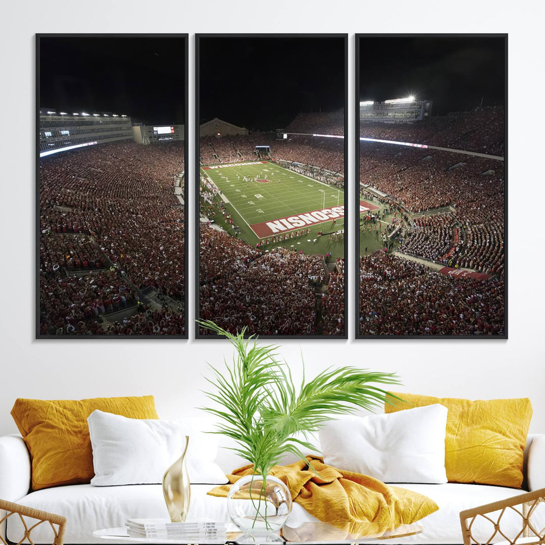 A painting of a stadium packed for a Wisconsin Badgers game, with WISCONSIN clearly visible in the end zone at Camp Randall Stadium.