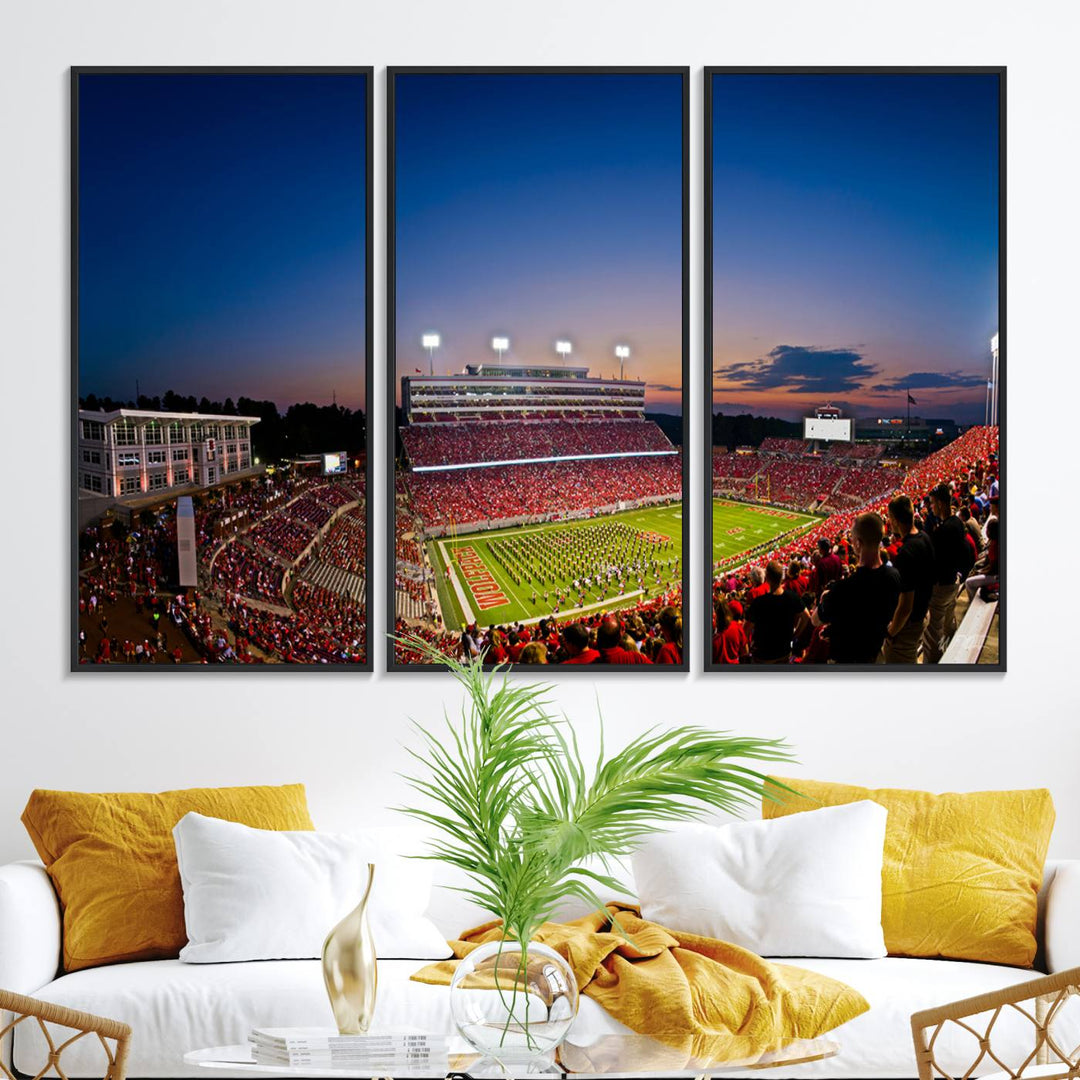 The Wolfpack Football Team Print captures a band and crowd at dusk in a premium canvas art style at Raleigh Carter-Finley Stadium.