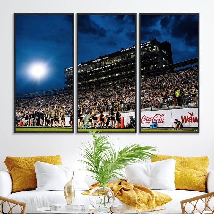 A gallery-quality canvas print depicting a stadium packed with fans under a night sky, highlighting the UCF Knights Football Team.