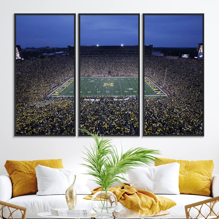 Wall art featuring an aerial shot of Michigan Stadium at dusk, showcasing the University of Michigan Wolverines M logo.