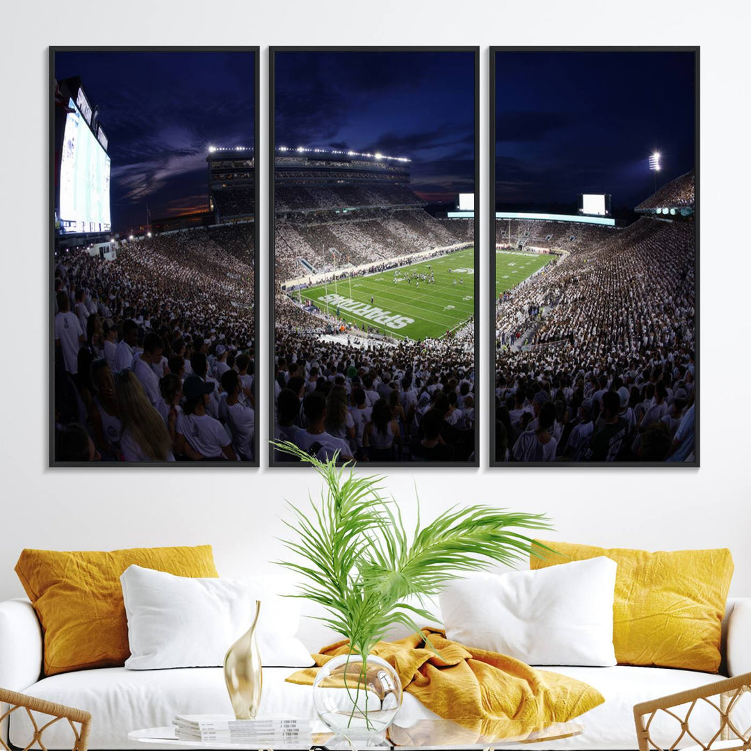 A packed football stadium at night, with bright lights and fans in white, depicted in a Michigan State Spartans Stadium wall art.