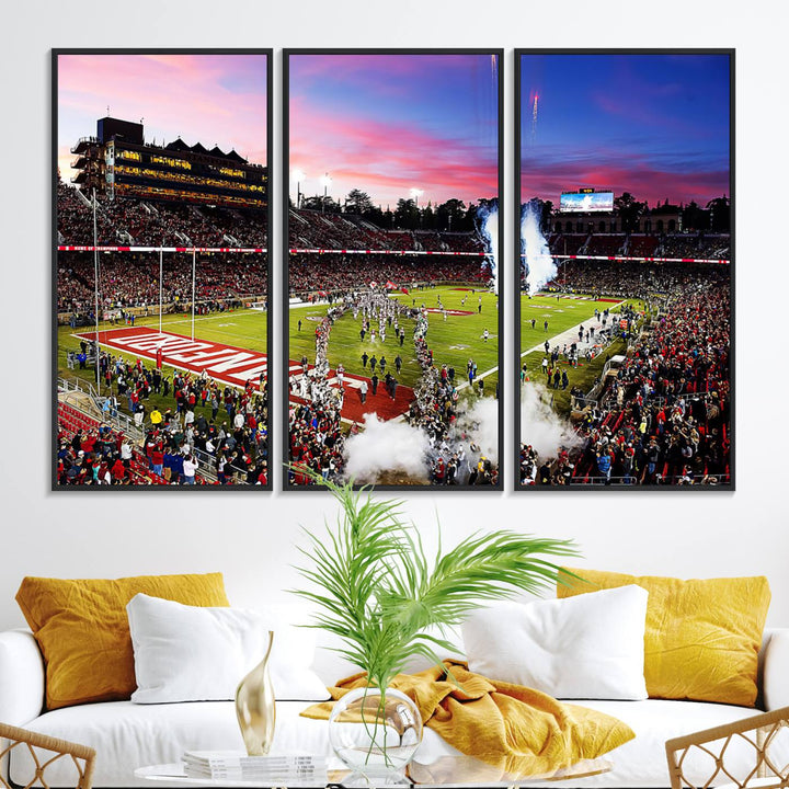 The wall art features a canvas print of the Stanford Cardinal football team, capturing players, fireworks, and smoke against the backdrop of a sunset at Stanford Stadium.