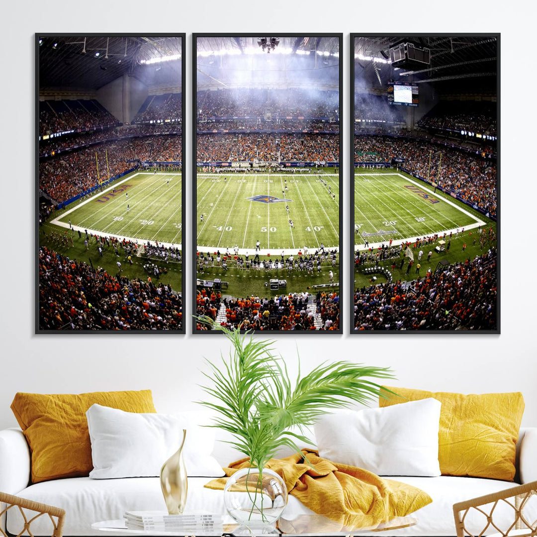 The modern living room features an Alamodome wall art canvas print, depicting a stadium filled with spectators for a UTSA Roadrunners game.