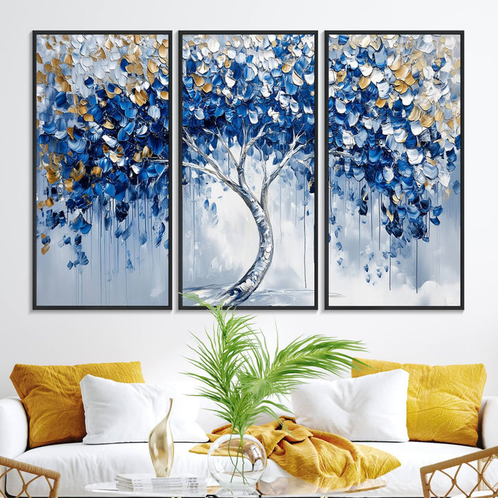 The Blue and Gold Abstract Tree Wall Art showcases a swirl trunk and features blue, silver, and gold leaves on a framed canvas print.