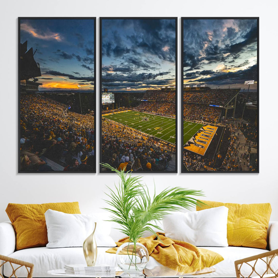 Laramies War Memorial Stadium Print captures a stunning scene of the stadium during sunset, set under a partly cloudy sky illuminated by bright lights.