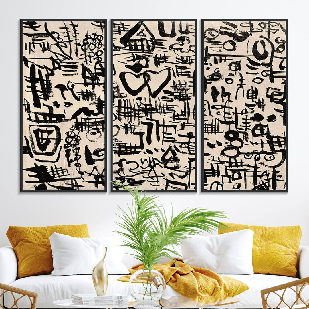 The Abstract Love and Chaos canvas is a museum-quality print featuring black symbols on a beige background, adorned with a heart and scribble design. It is framed to enhance its artistic appeal.