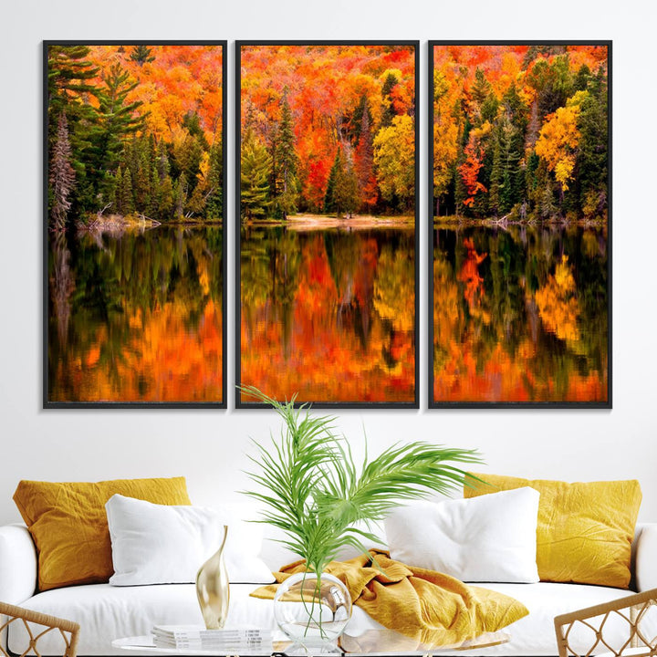 Autumn Forest Reflection Wall Art: a vibrant triptych canvas featuring fall foliage with red, orange, and yellow leaves over a calm lake.