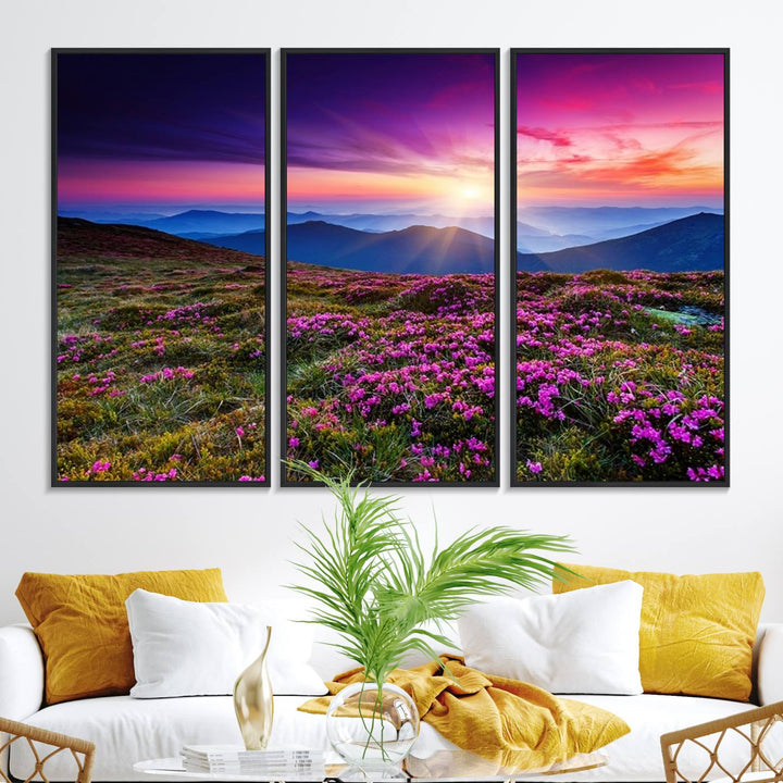 A 3-panel landscape photography canvas of a sunset over mountain meadows with purple wildflowers decorates the wall.