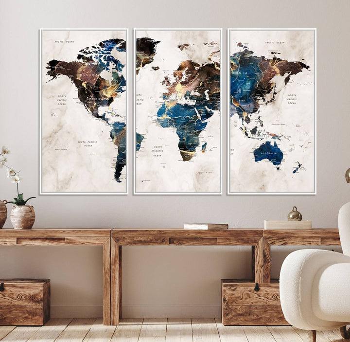 Abstract earth-toned 3-panel world map wall art featuring blues and browns, ready to hang; it showcases continents on modern canvas.