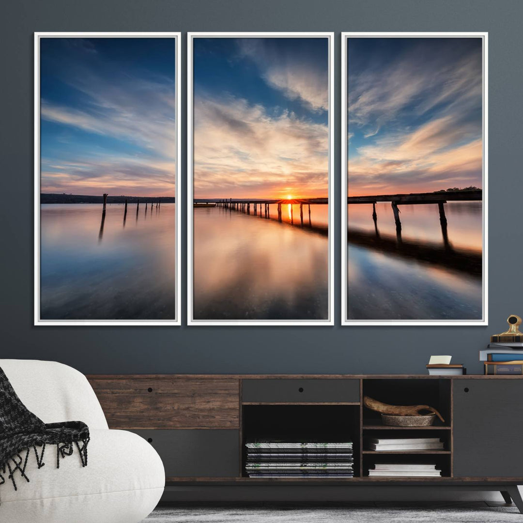 The Sunset Pier Canvas features a serene coastal landscape with vibrant hues under cloudy skies, ideal for modern decor.