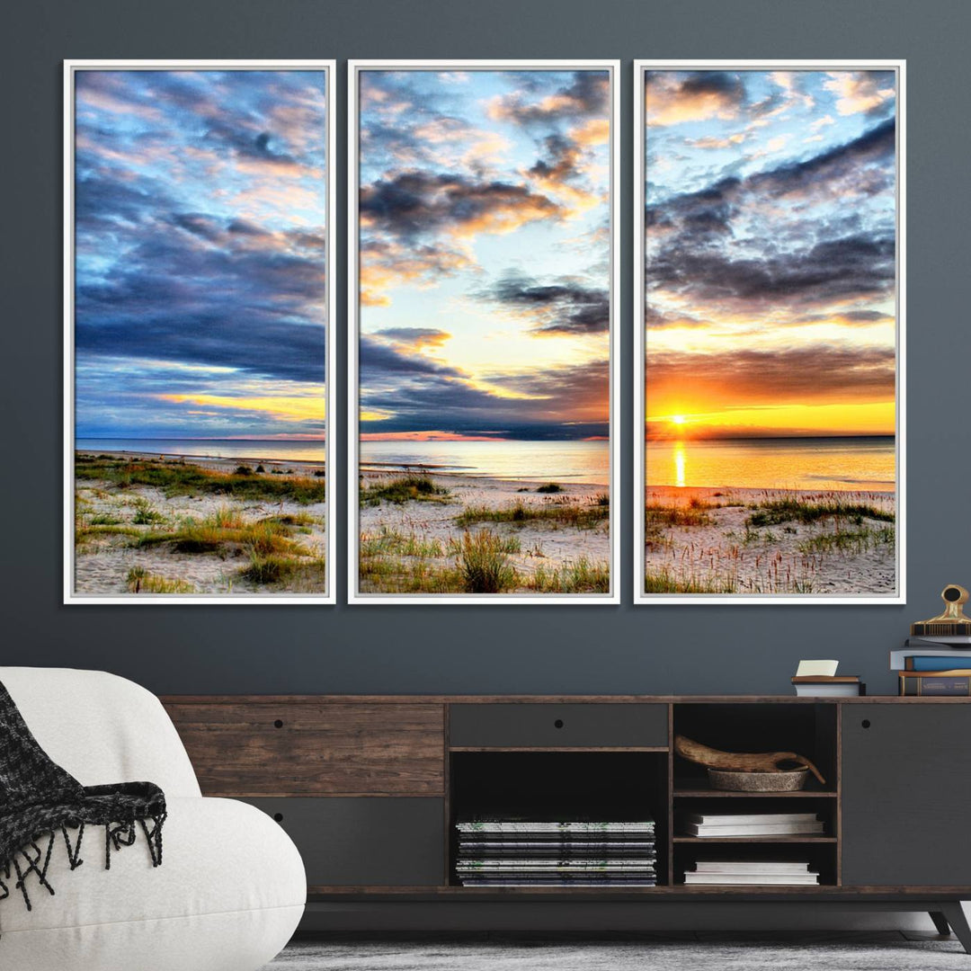 The Sunset On The Ocean canvas wall art features a beautiful beach sunset with grass and clouds.