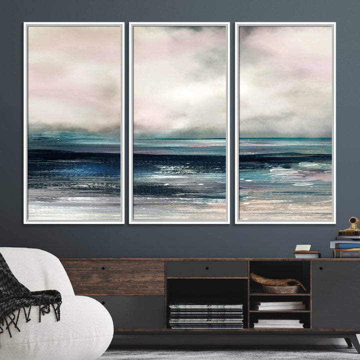 A contemporary abstract wall art canvas print in pastel pink, teal, and gray tones hangs on the wall.