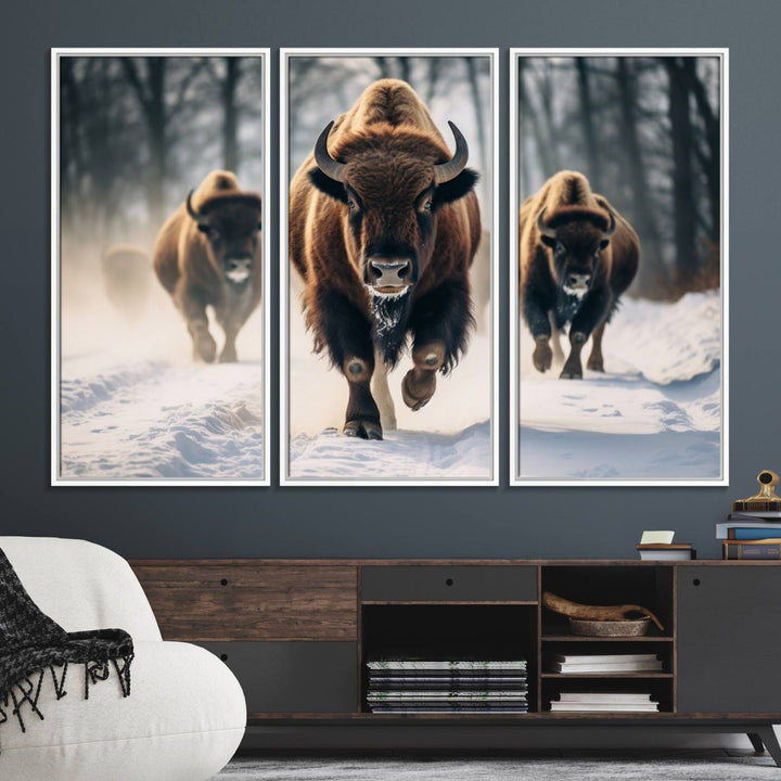 Wall art titled Cow Bighorn shows three bison running through snow in a forest.