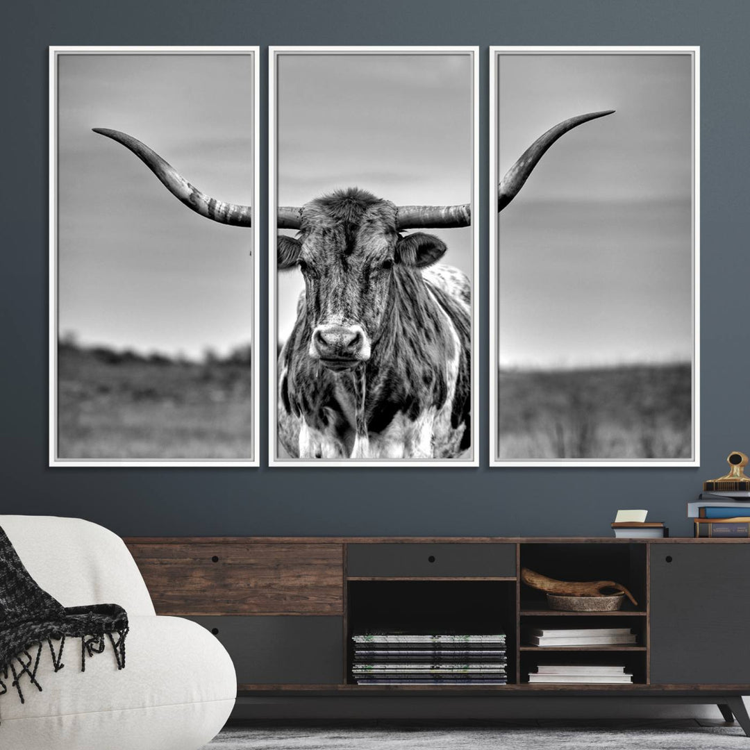 The Texas Longhorn Cow wall art, divided into three panels, is of gallery quality and displayed on a dark wall.